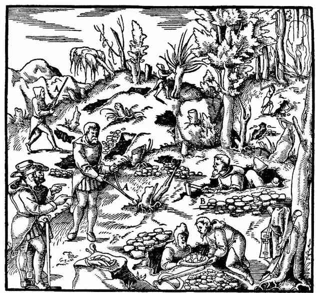 A woodcut: a man holding a forked twig over the ground while others dig the trenches it has pointed them to.