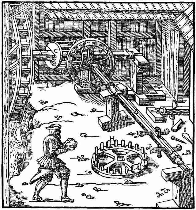 A woodcut: a man standing at a loose toothed wheel that lies on the ground, while behind him the shafts and gearing of a water-driven mill run on.